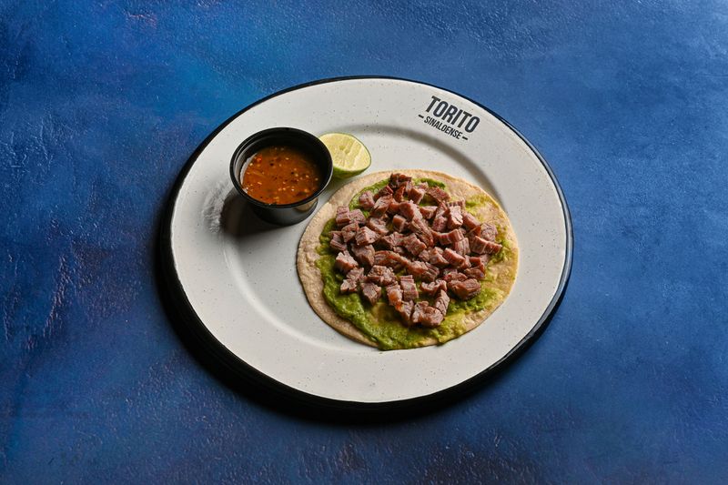 Barbacoa beef taco with avocado